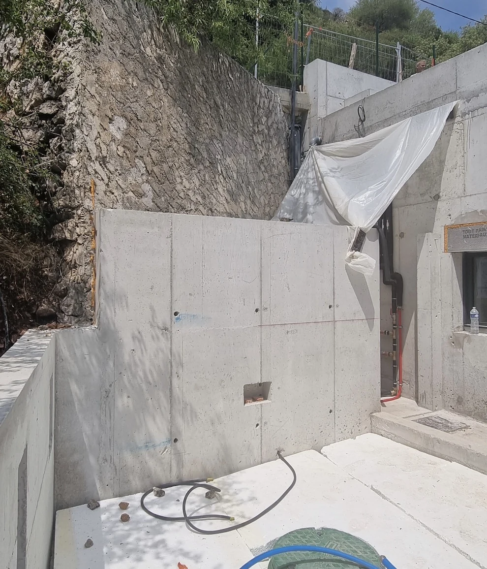 Mur de soutènement en béton brut avant habillage en faux rocher polyester