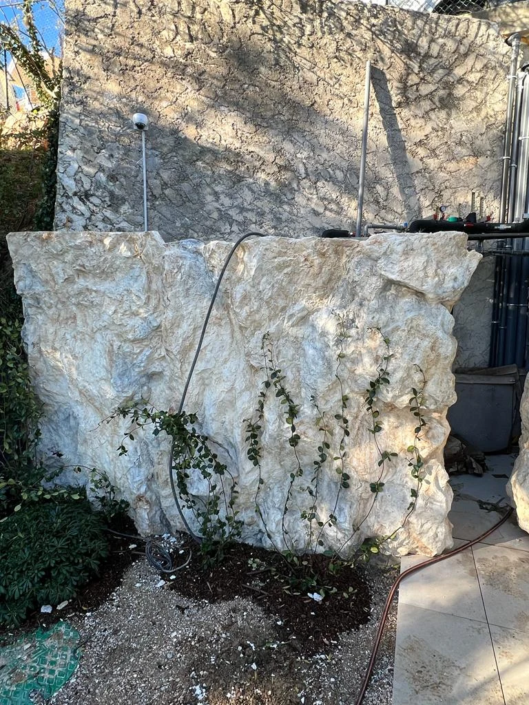 Faux rock technical cover with plants